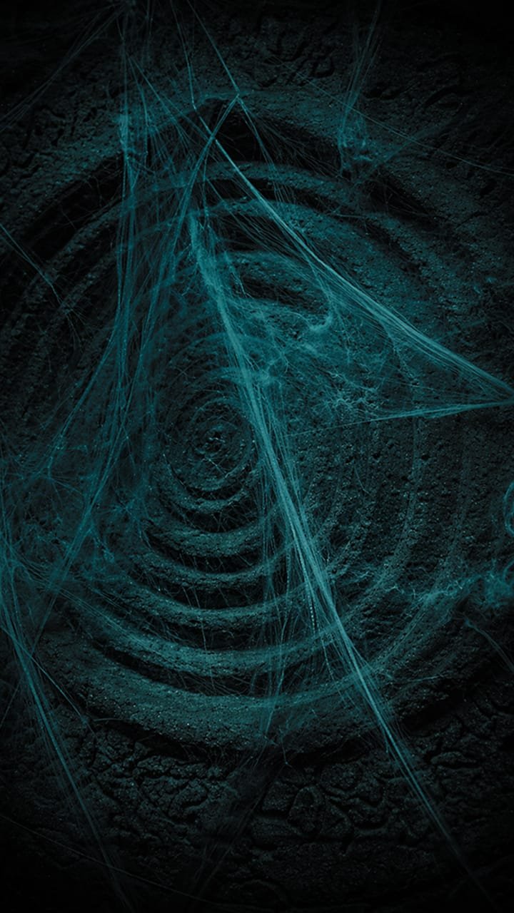 Spiral stone carving with glowing cobwebs
